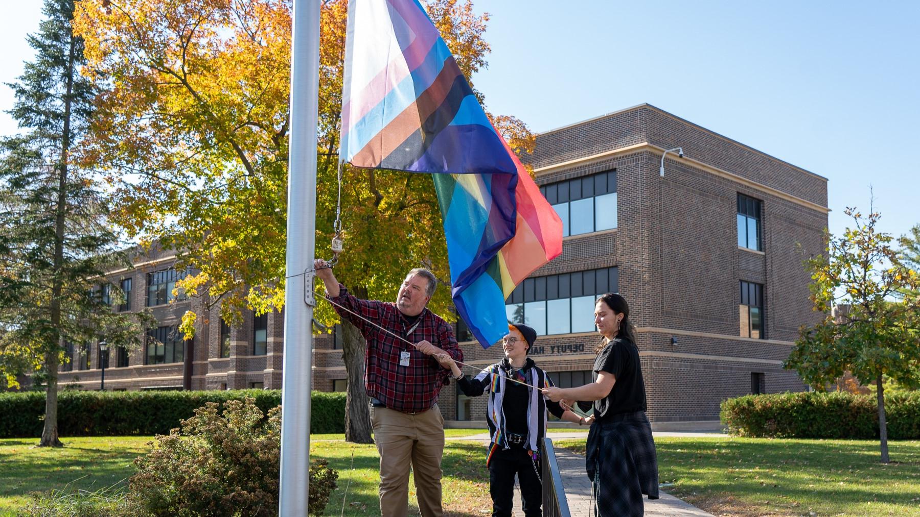 Students and Staff Raising Pride Flag